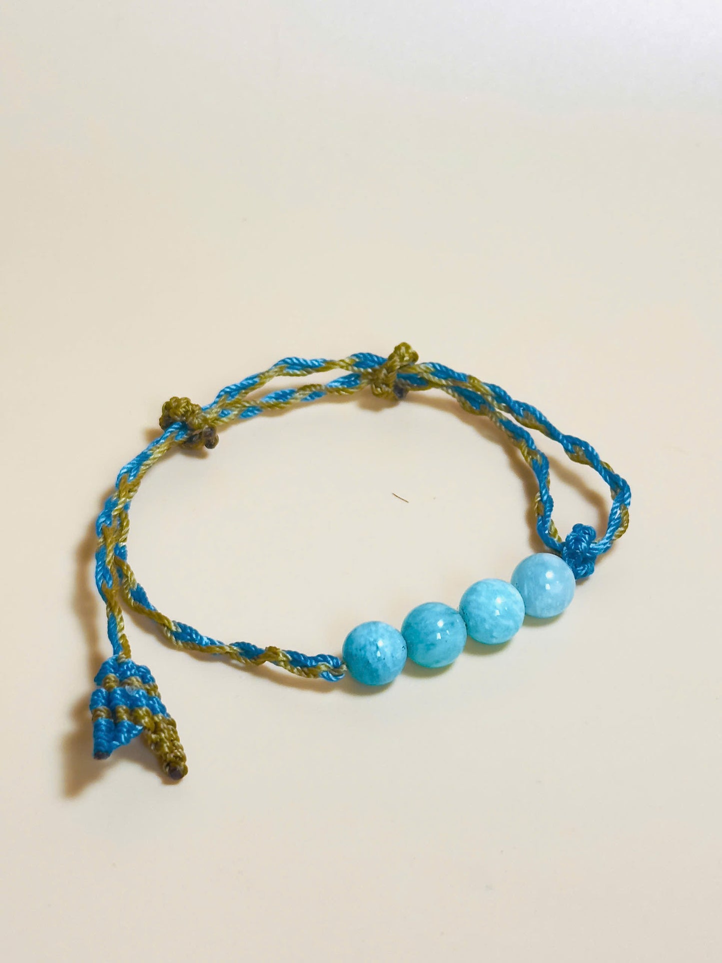 Aquamarine bracelet with soft blue tones and whale tail knot