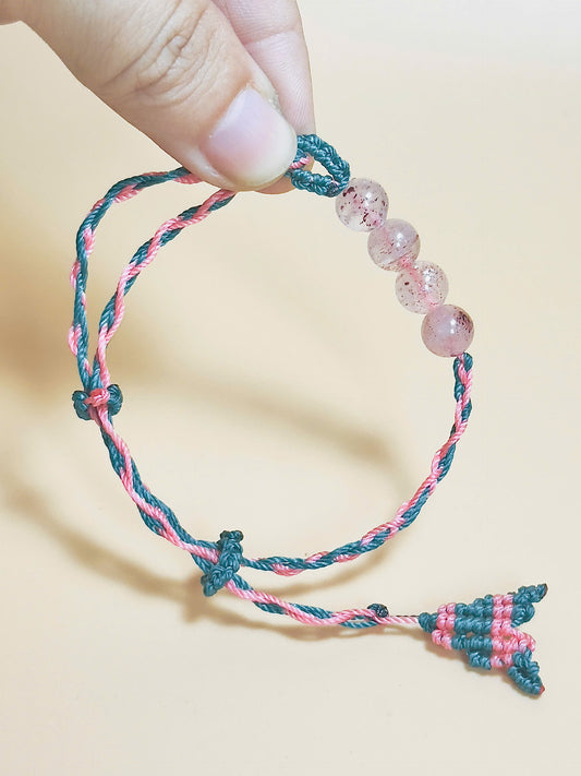 Pink strawberry quartz bracelet with whale tail closure on hand