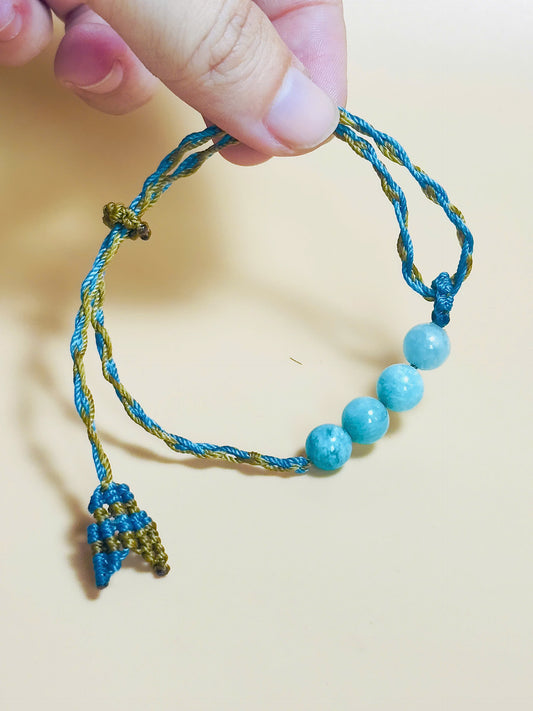 Aquamarine bracelet with soft blue tones and whale tail knot