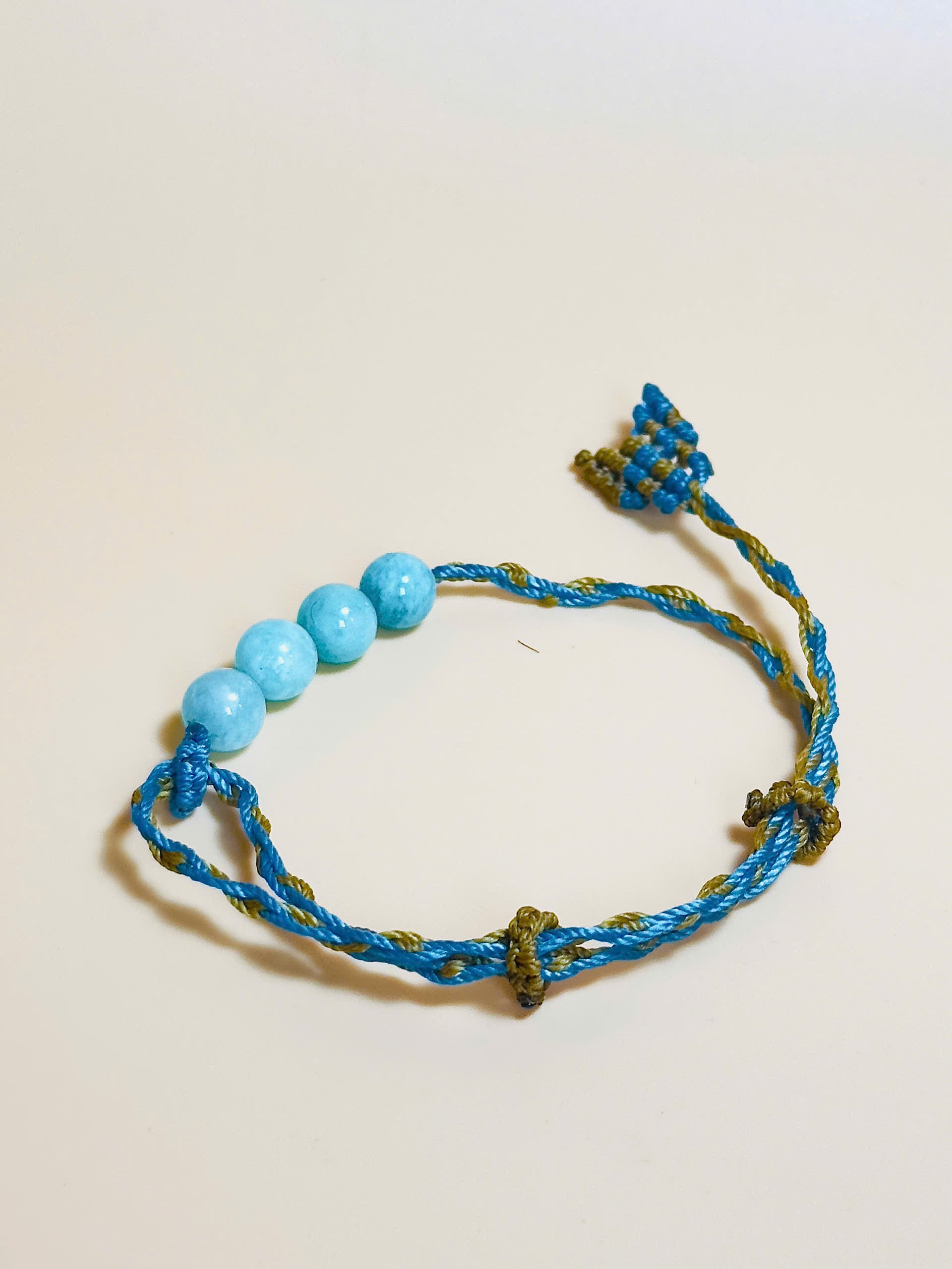 Aquamarine bracelet with soft blue tones and whale tail knot