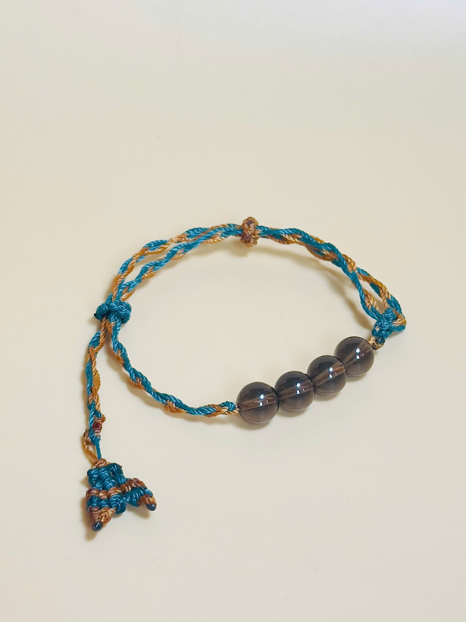Smoky quartz bracelet in earthy tones with handmade whale tail knot