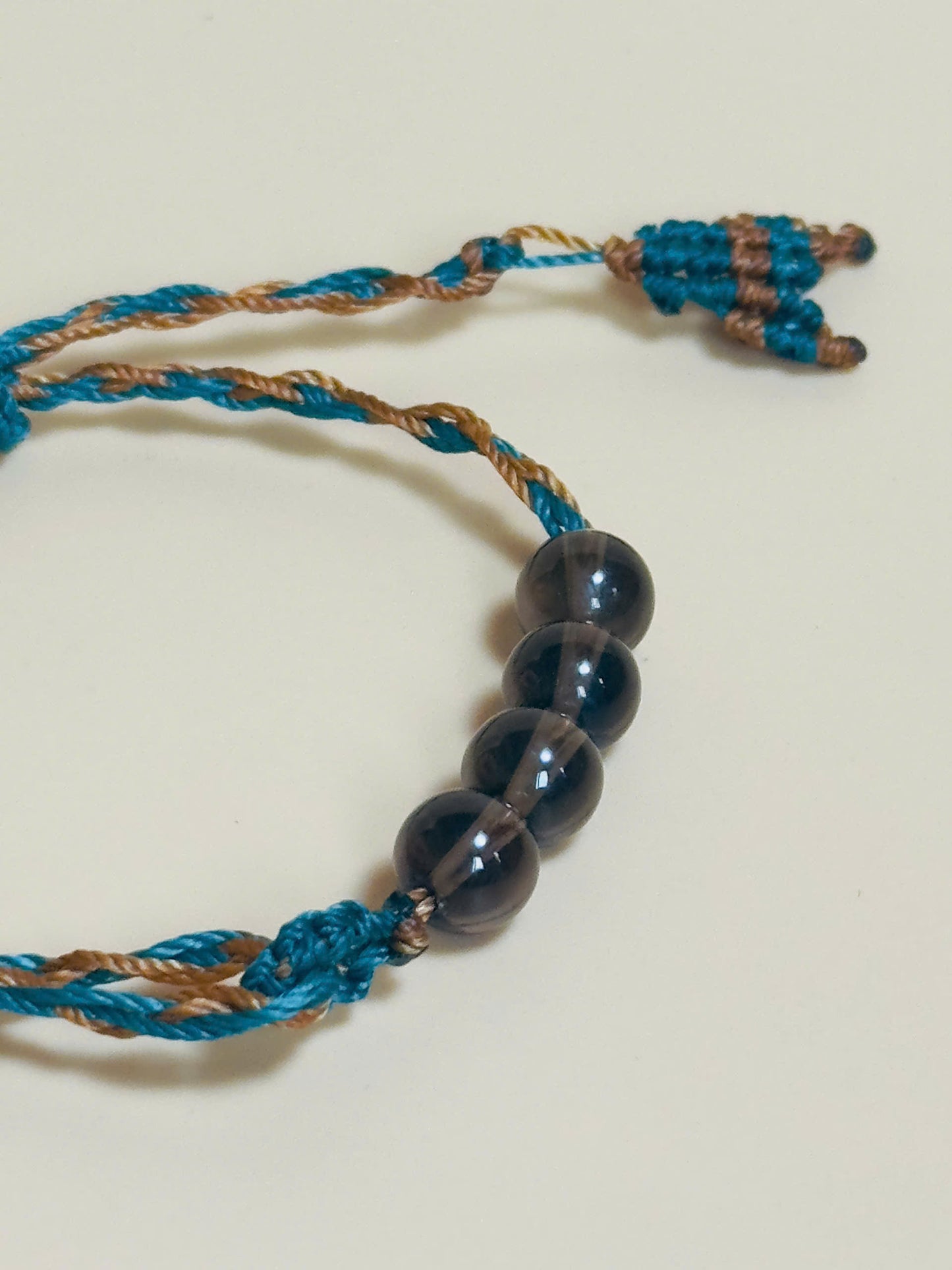 Smoky quartz bracelet in earthy tones with handmade whale tail knot