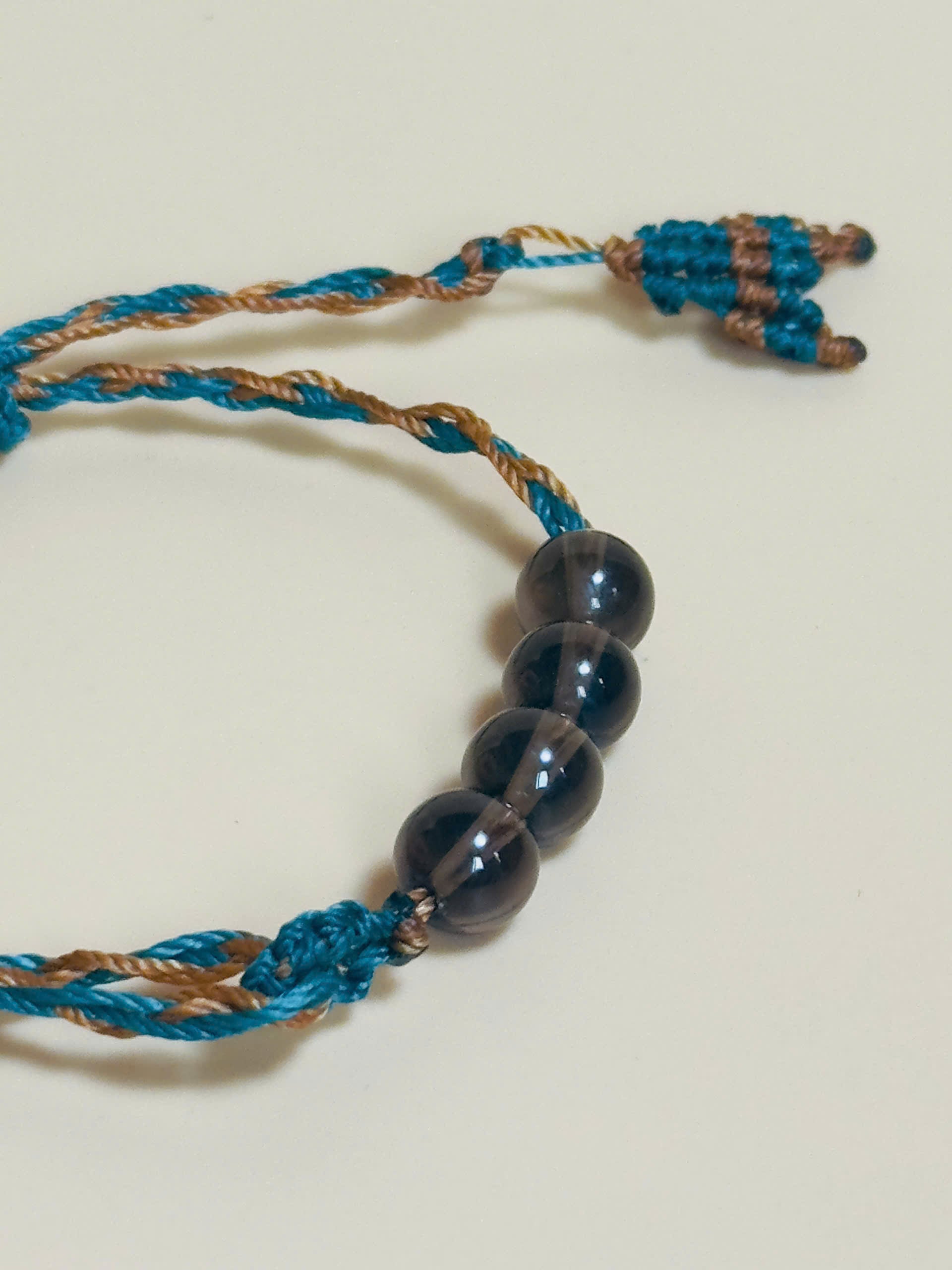 Smoky quartz bracelet in earthy tones with handmade whale tail knot