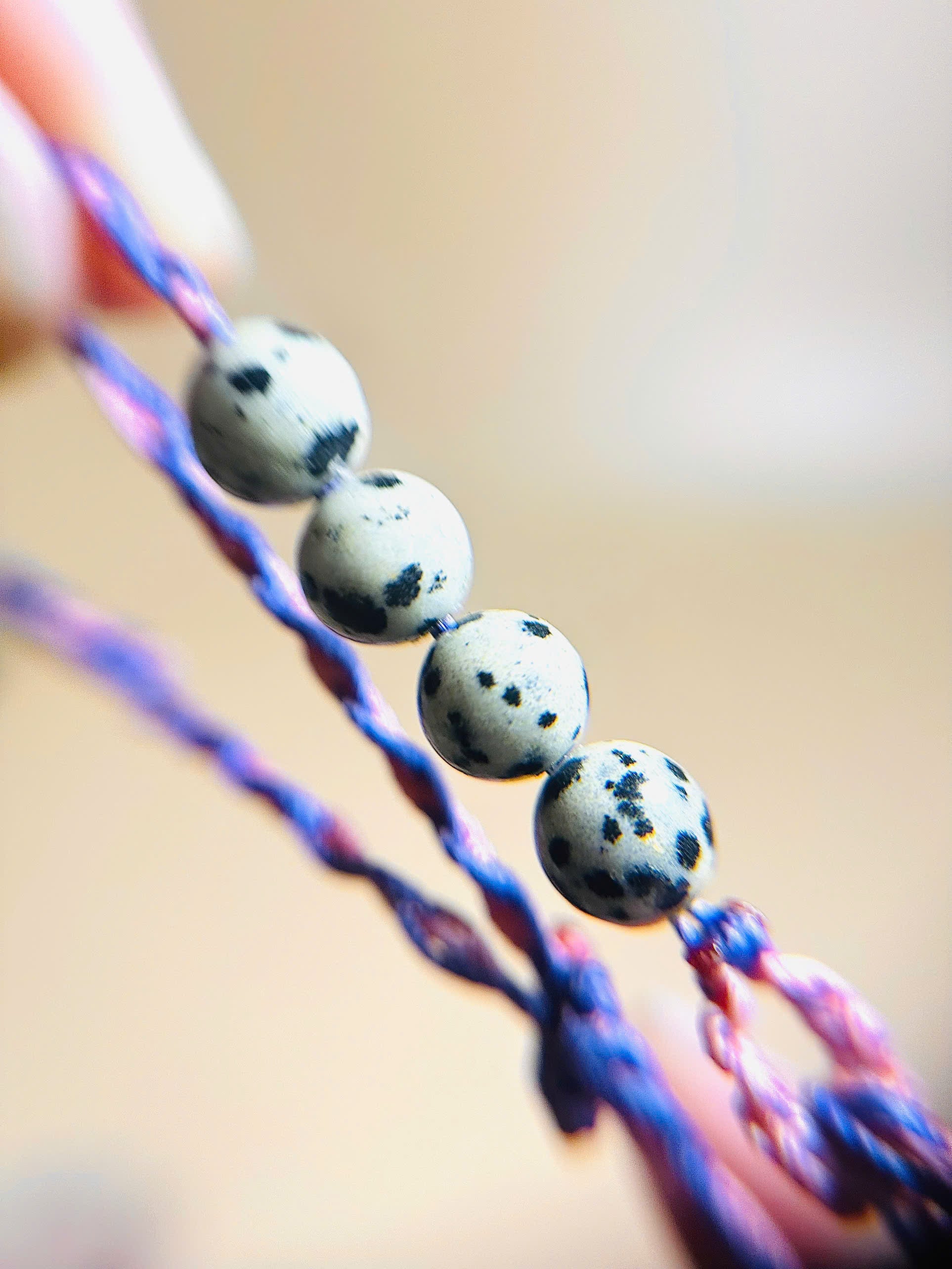 Dalmatian jasper bracelet with spotted stones and whale tail detail