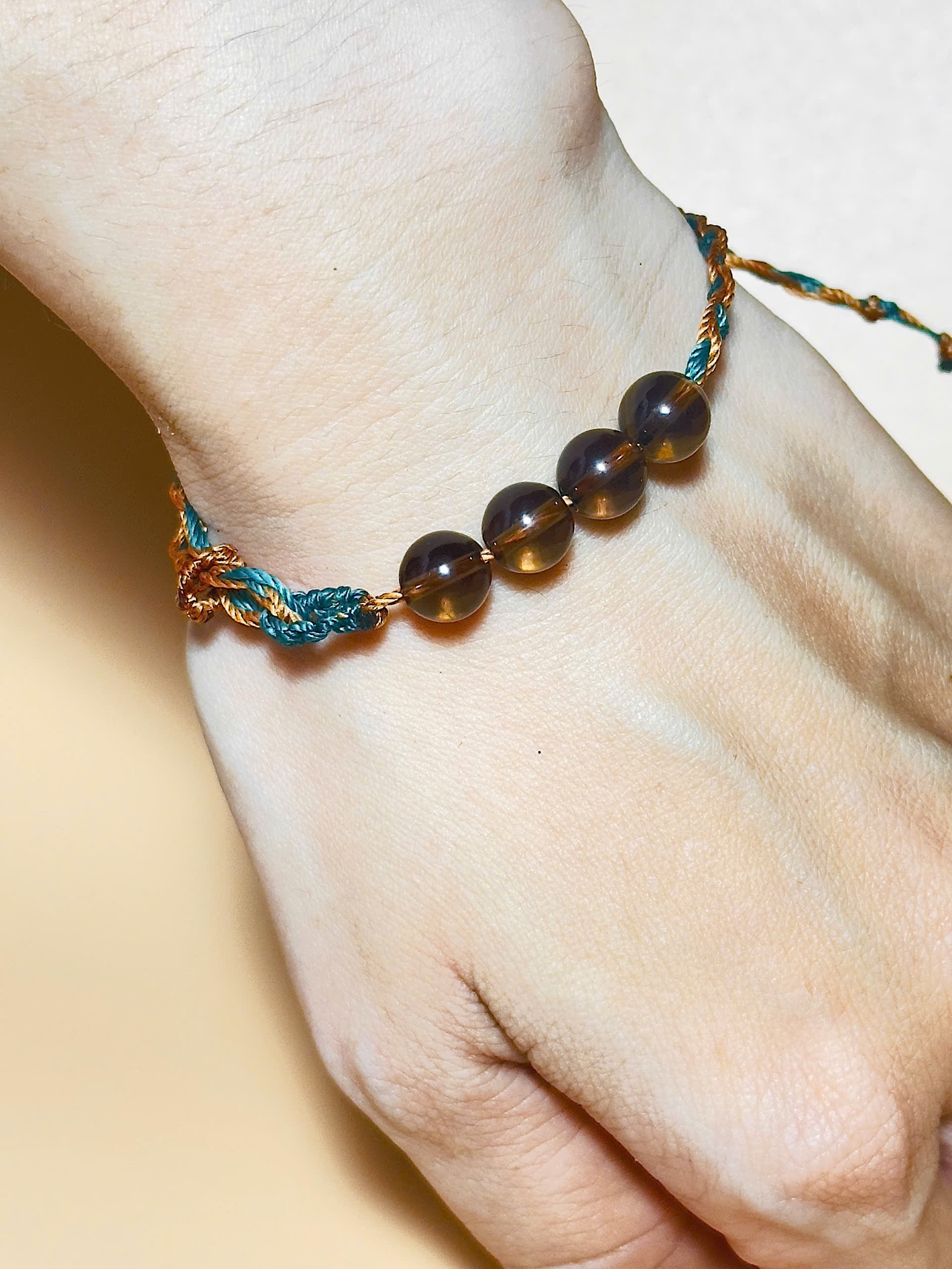 Smoky quartz bracelet in earthy tones with handmade whale tail knot