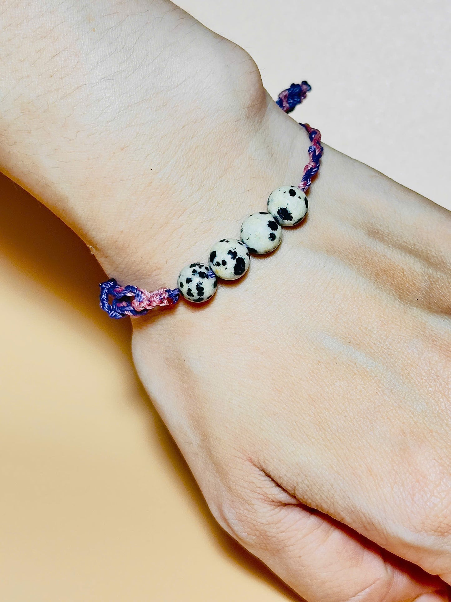 Dalmatian jasper bracelet with spotted stones and whale tail detail