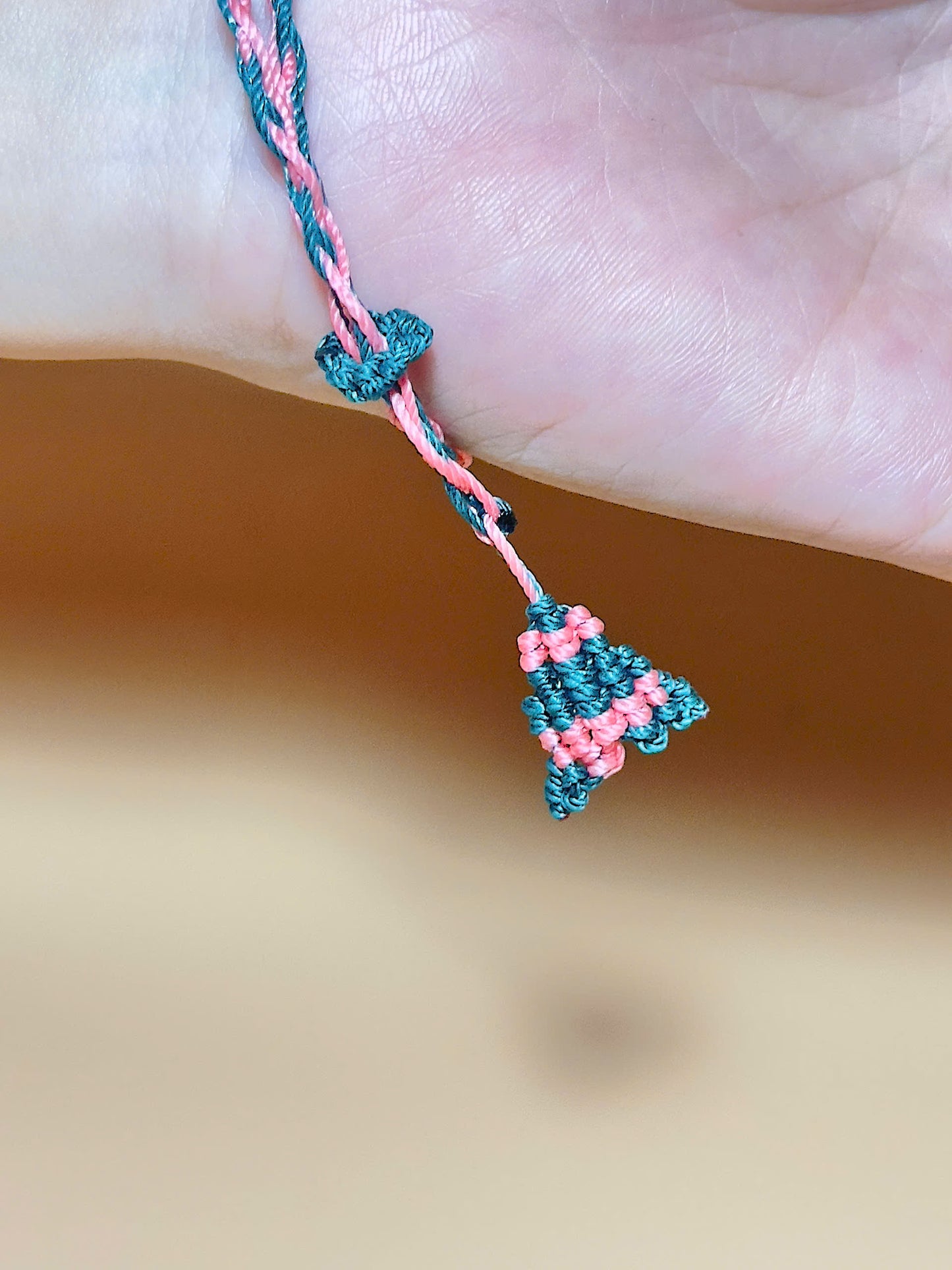 Pink strawberry quartz bracelet with whale tail closure on hand