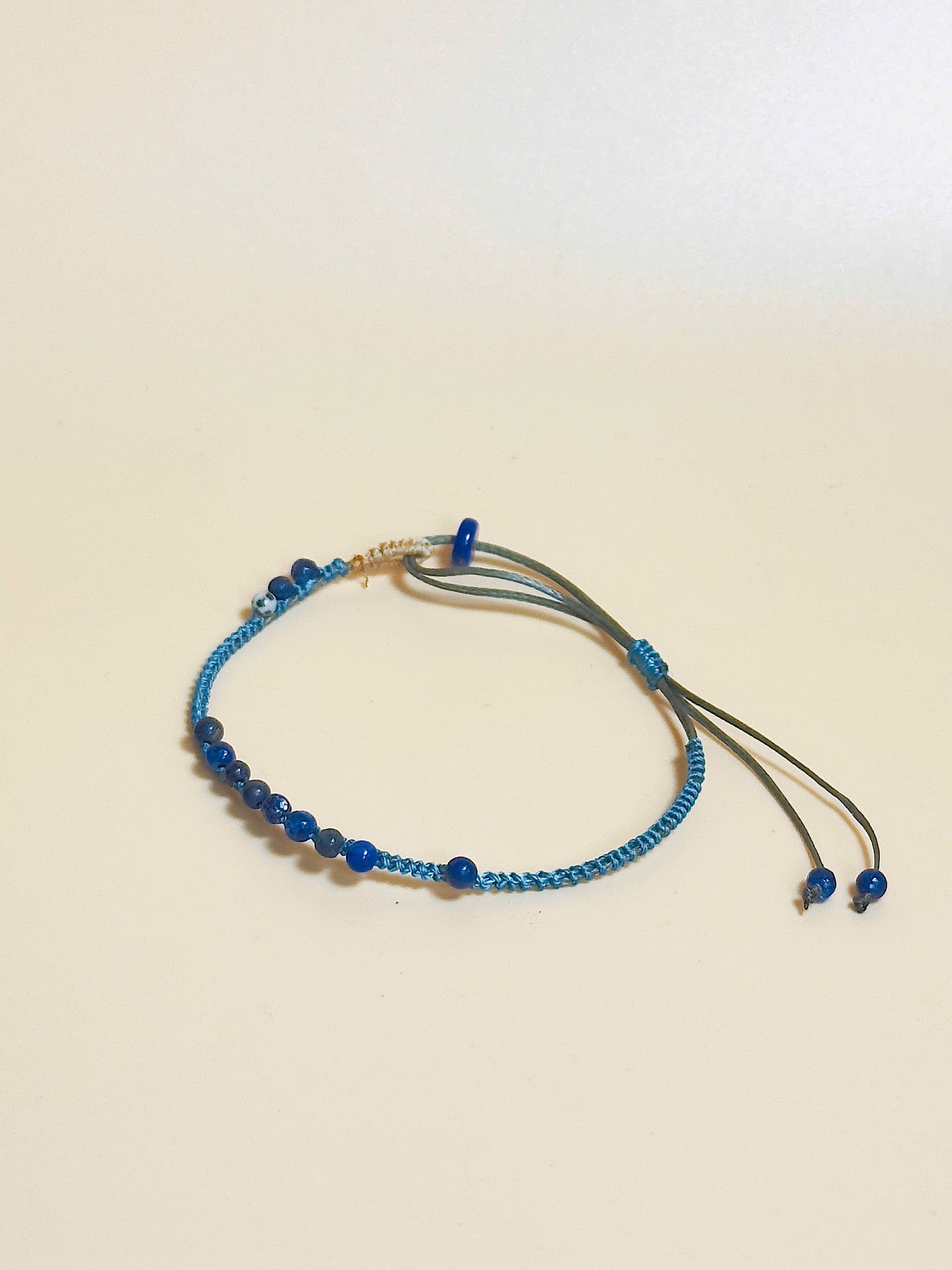 “Blue lapis lazuli bracelet with 2.5mm gemstone beads and waxed adjustable cord – calming and minimal design”