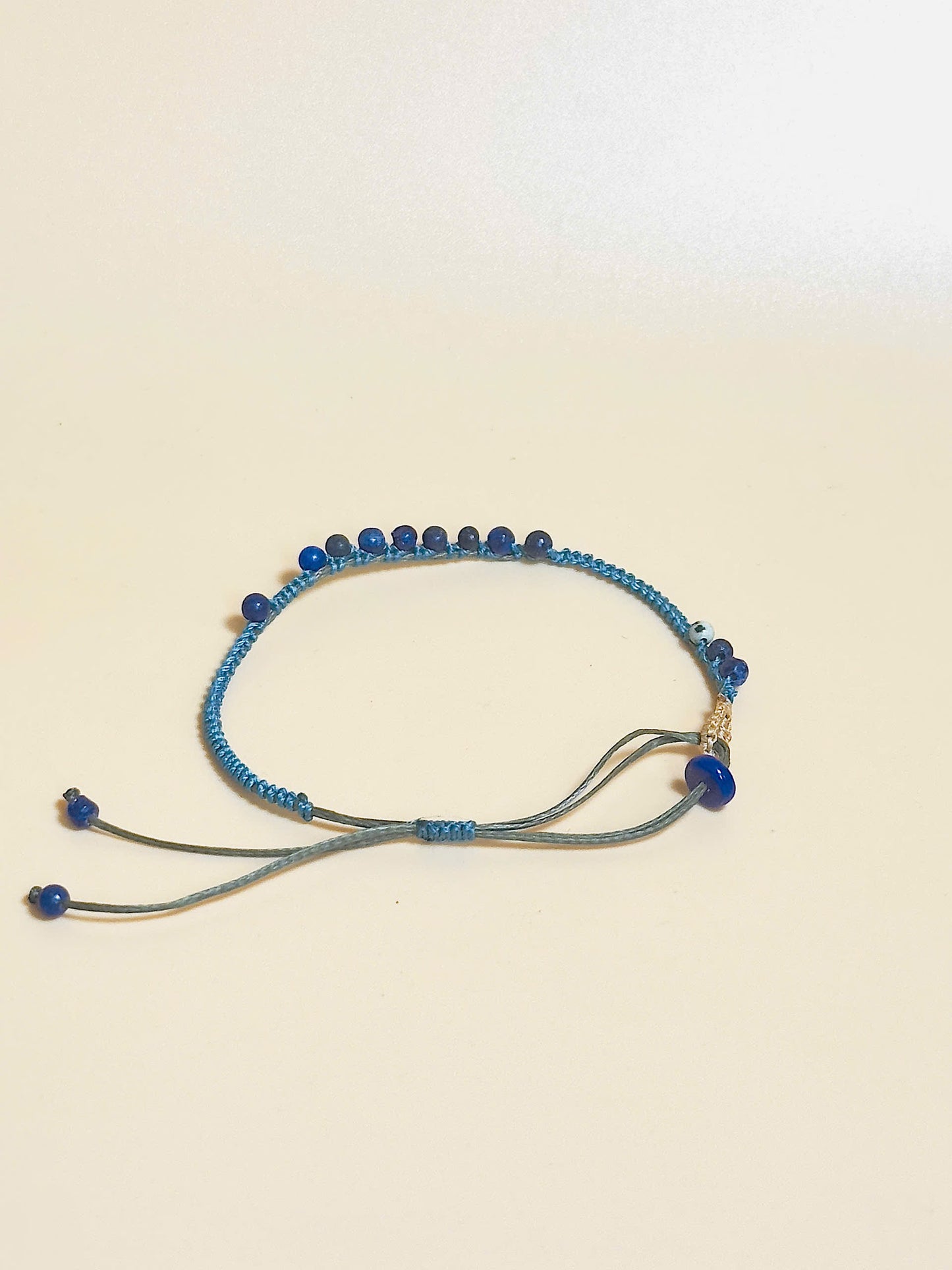 “Blue lapis lazuli bracelet with 2.5mm gemstone beads and waxed adjustable cord – calming and minimal design”