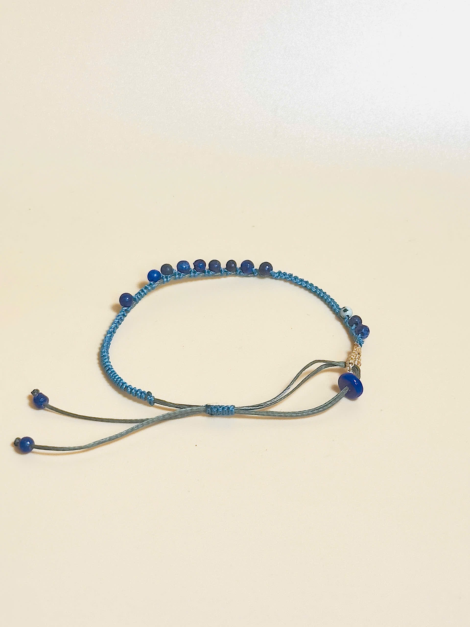 “Blue lapis lazuli bracelet with 2.5mm gemstone beads and waxed adjustable cord – calming and minimal design”