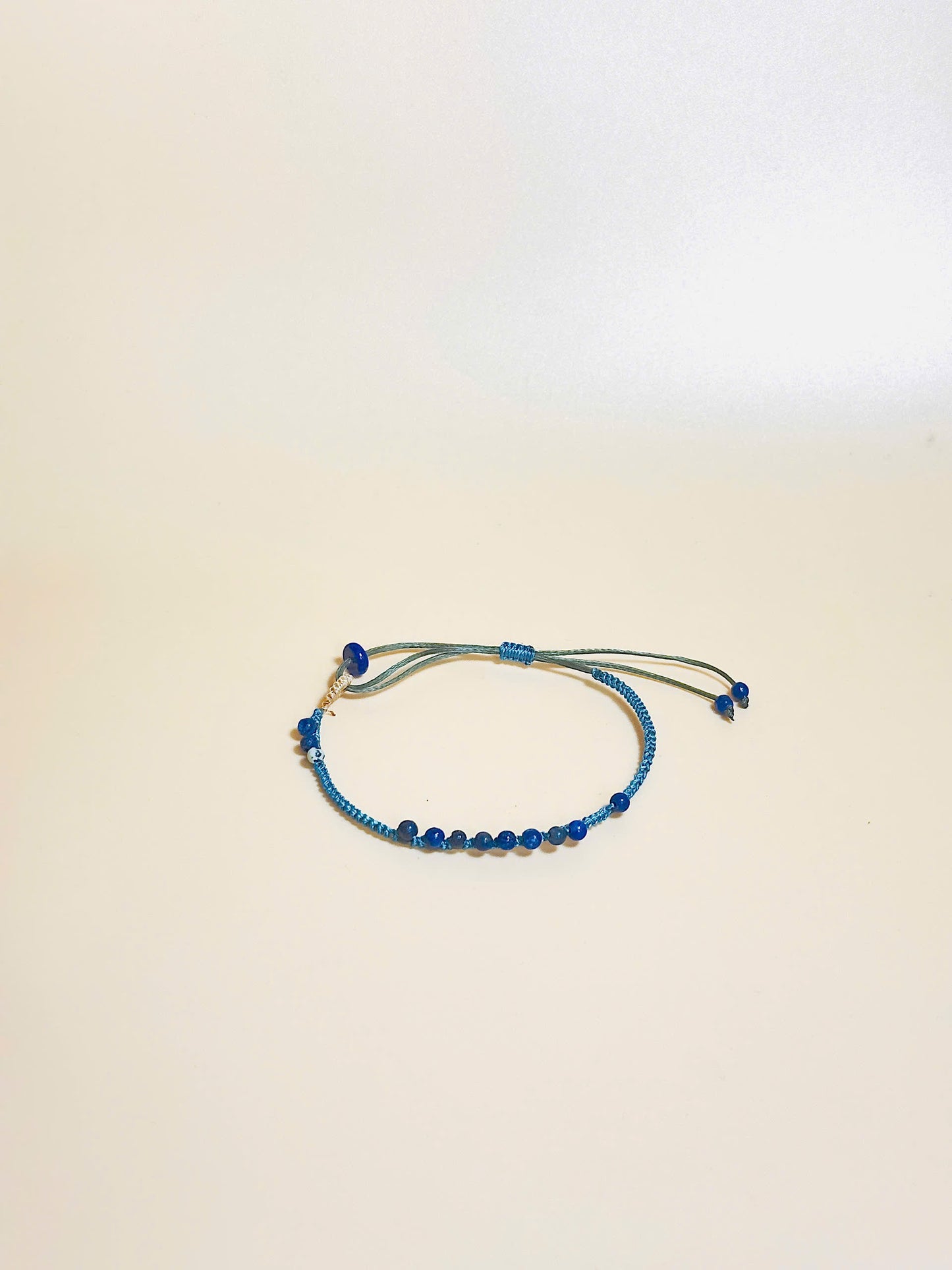 “Blue lapis lazuli bracelet with 2.5mm gemstone beads and waxed adjustable cord – calming and minimal design