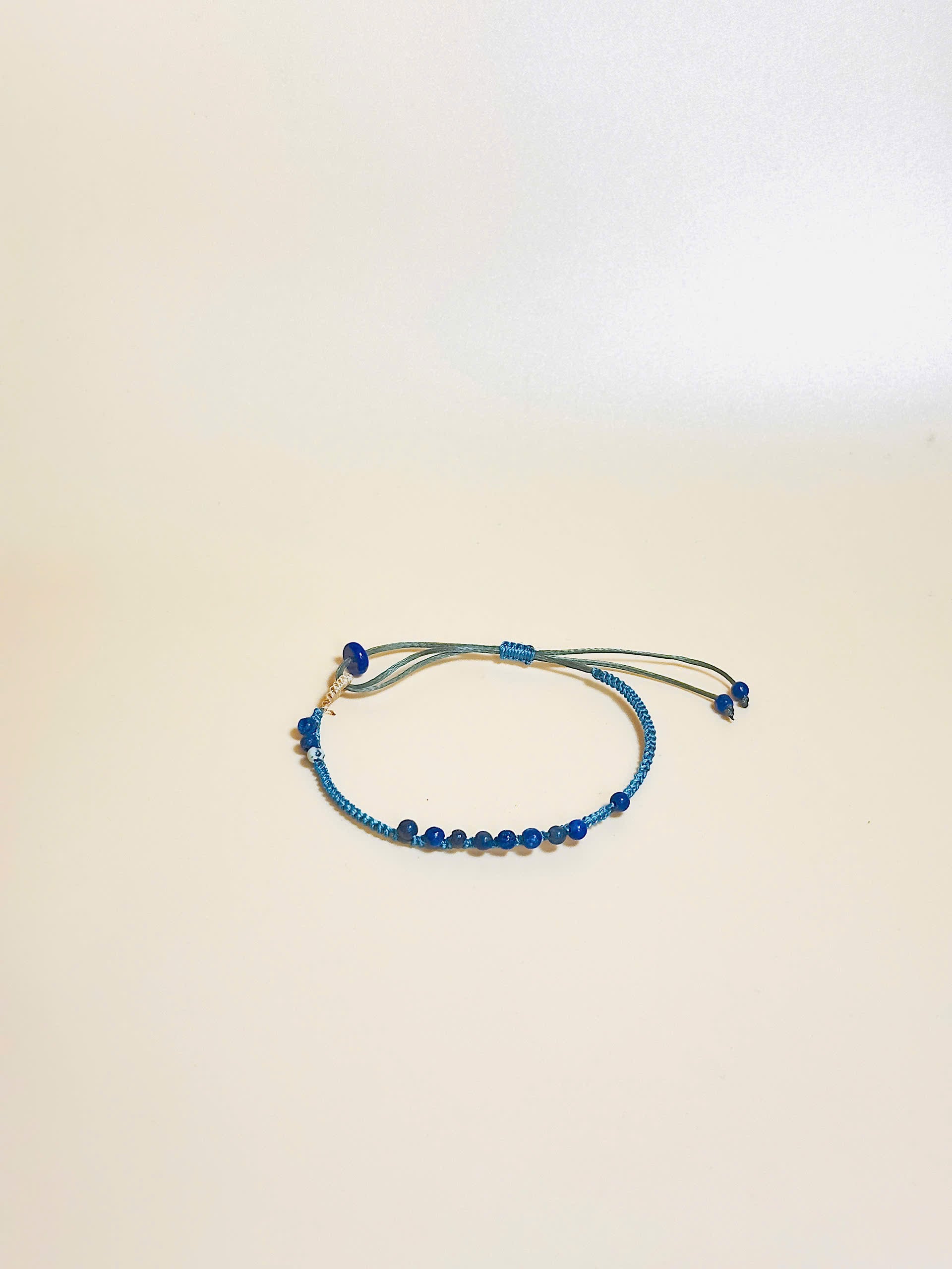 “Blue lapis lazuli bracelet with 2.5mm gemstone beads and waxed adjustable cord – calming and minimal design