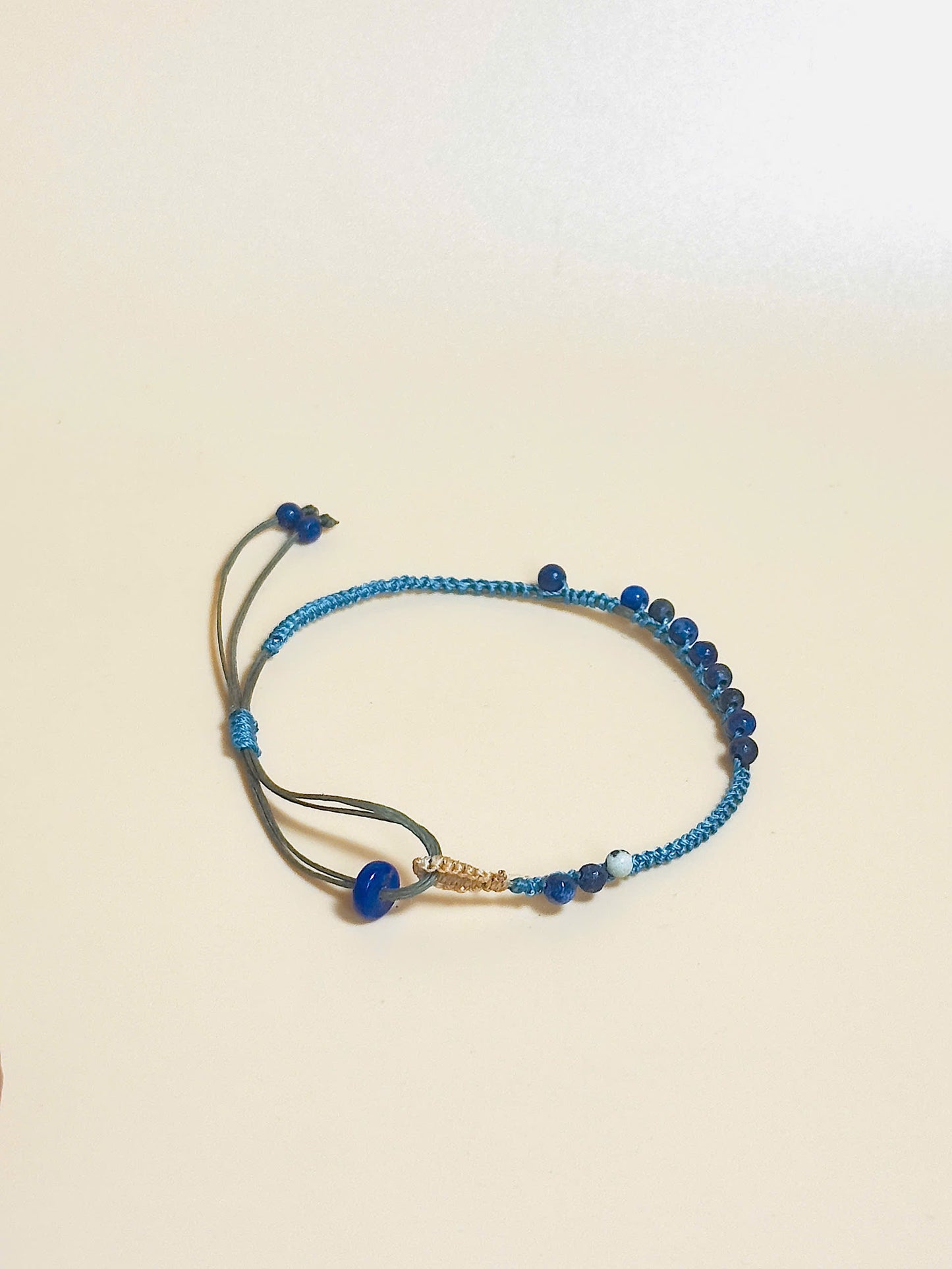 “Blue lapis lazuli bracelet with 2.5mm gemstone beads and waxed adjustable cord – calming and minimal design”
