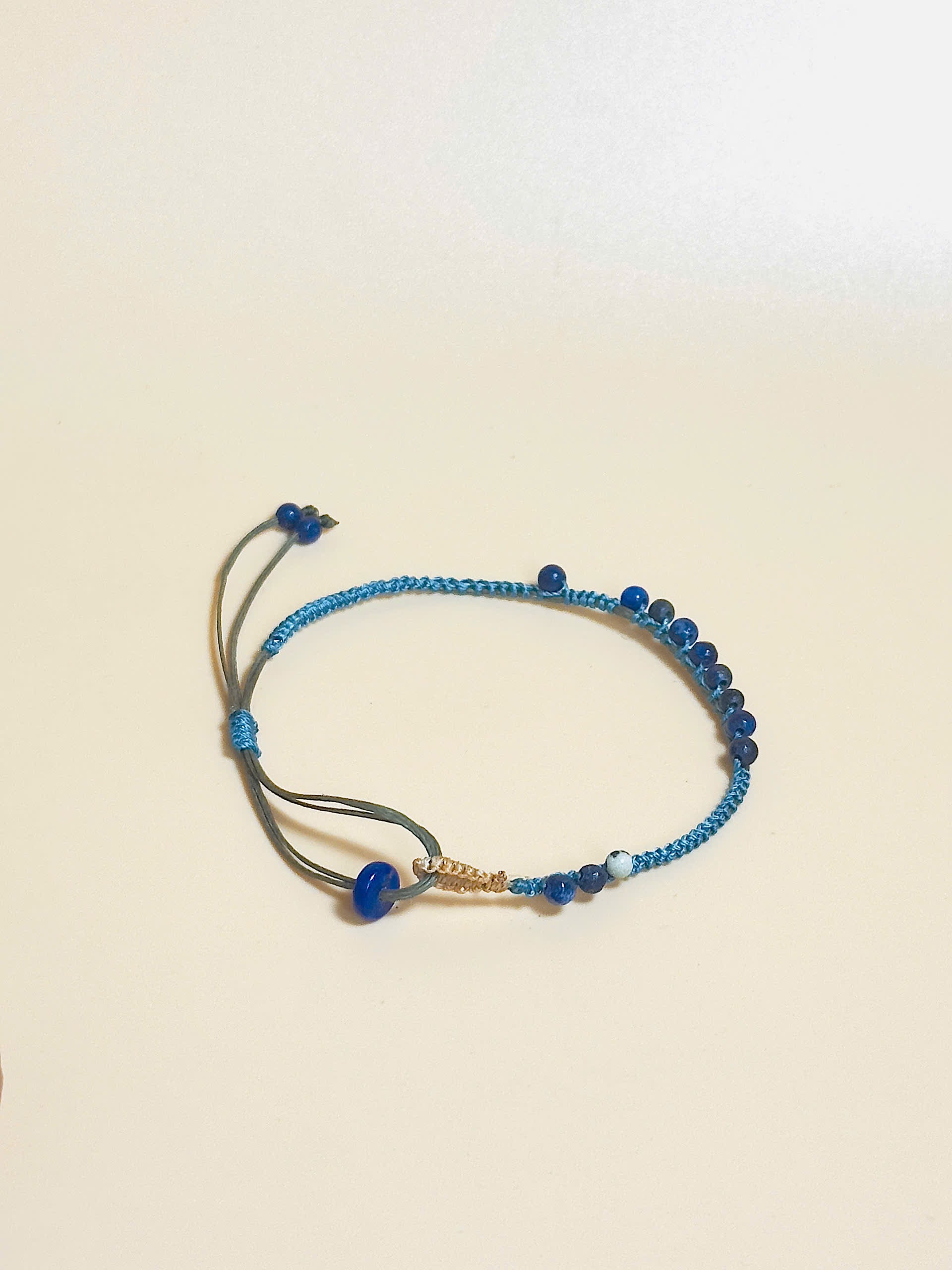 “Blue lapis lazuli bracelet with 2.5mm gemstone beads and waxed adjustable cord – calming and minimal design”