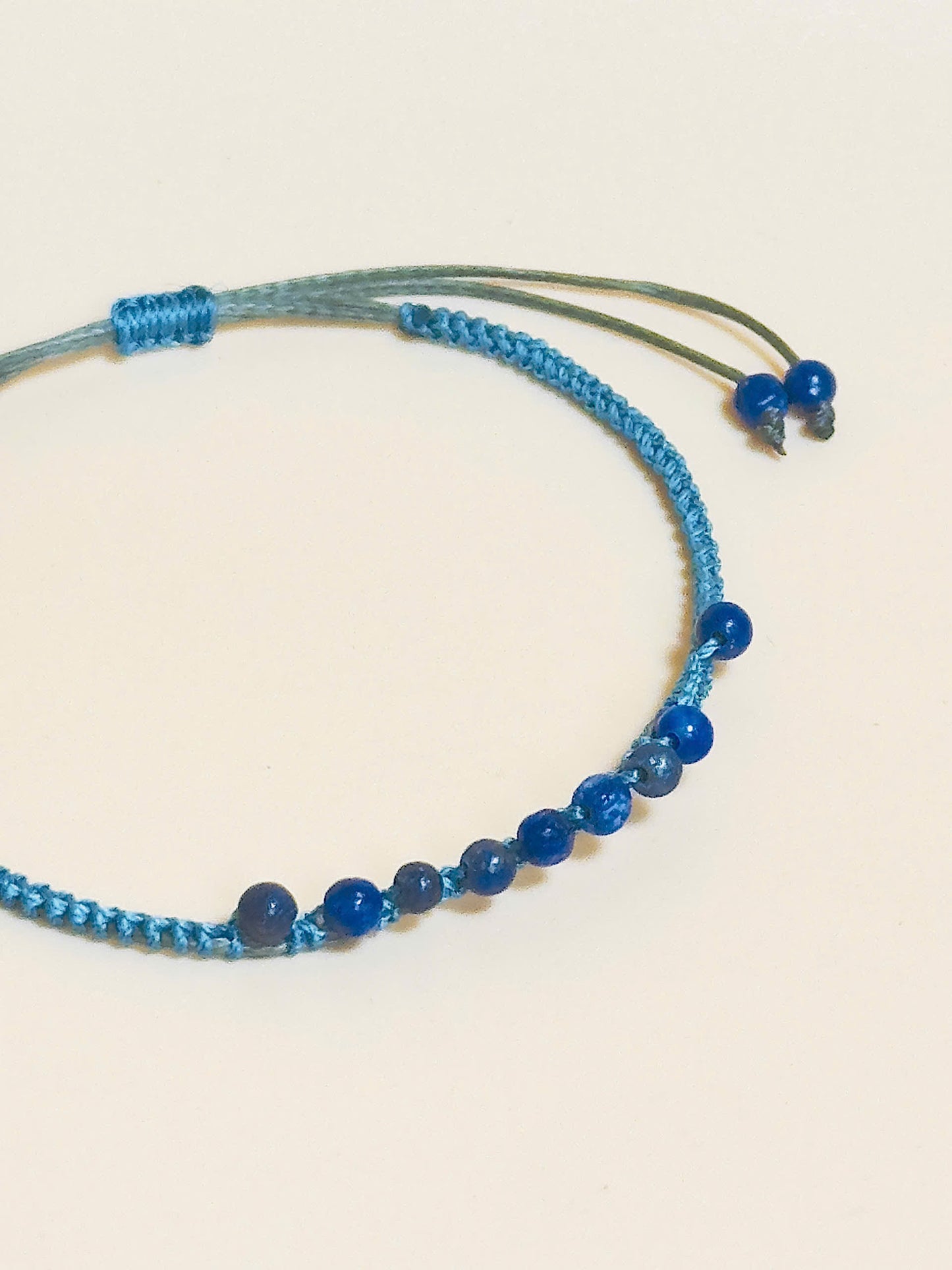 “Blue lapis lazuli bracelet with 2.5mm gemstone beads and waxed adjustable cord – calming and minimal design”