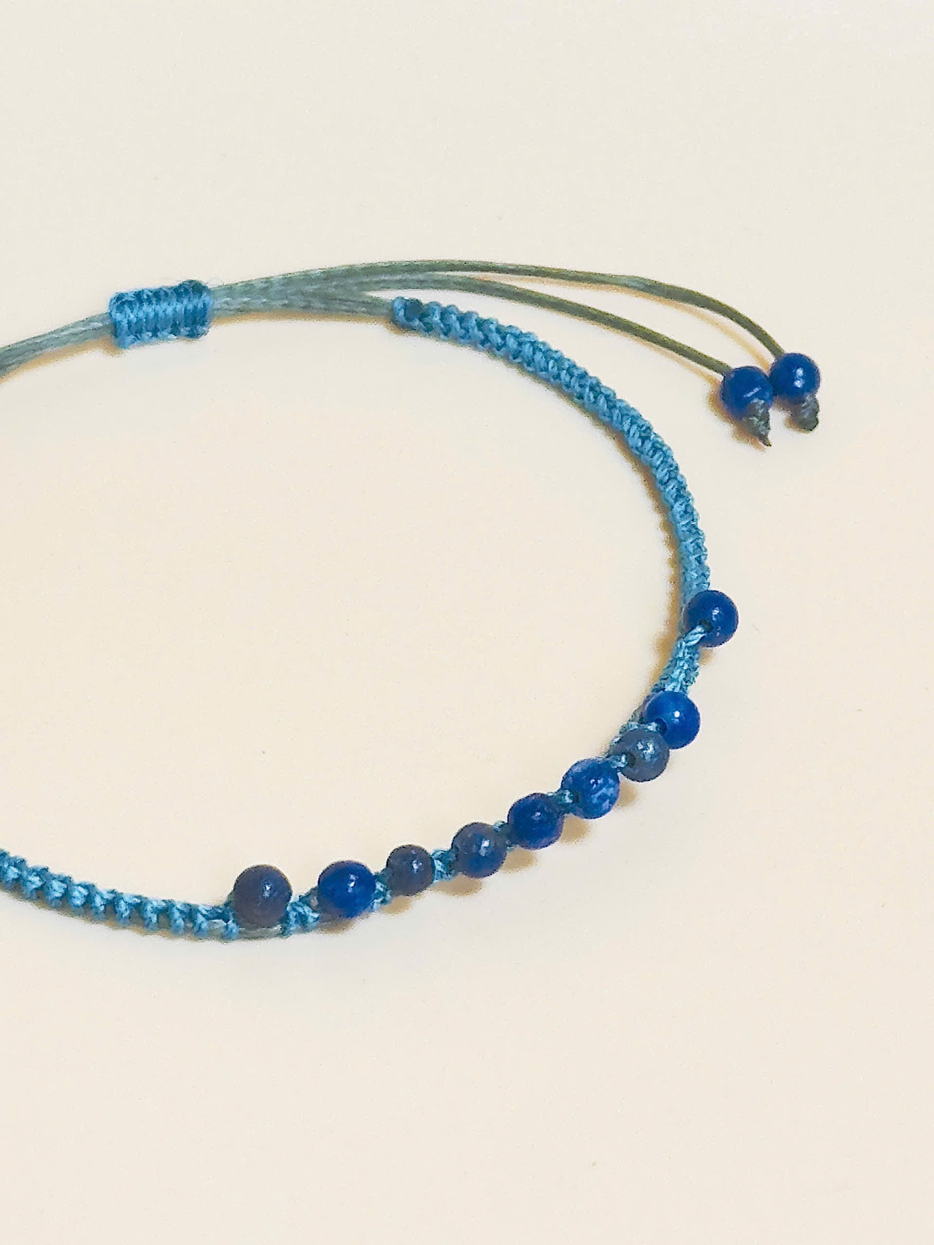 “Blue lapis lazuli bracelet with 2.5mm gemstone beads and waxed adjustable cord – calming and minimal design”
