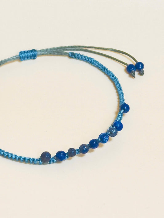 “Blue lapis lazuli bracelet with 2.5mm gemstone beads and waxed adjustable cord – calming and minimal design”