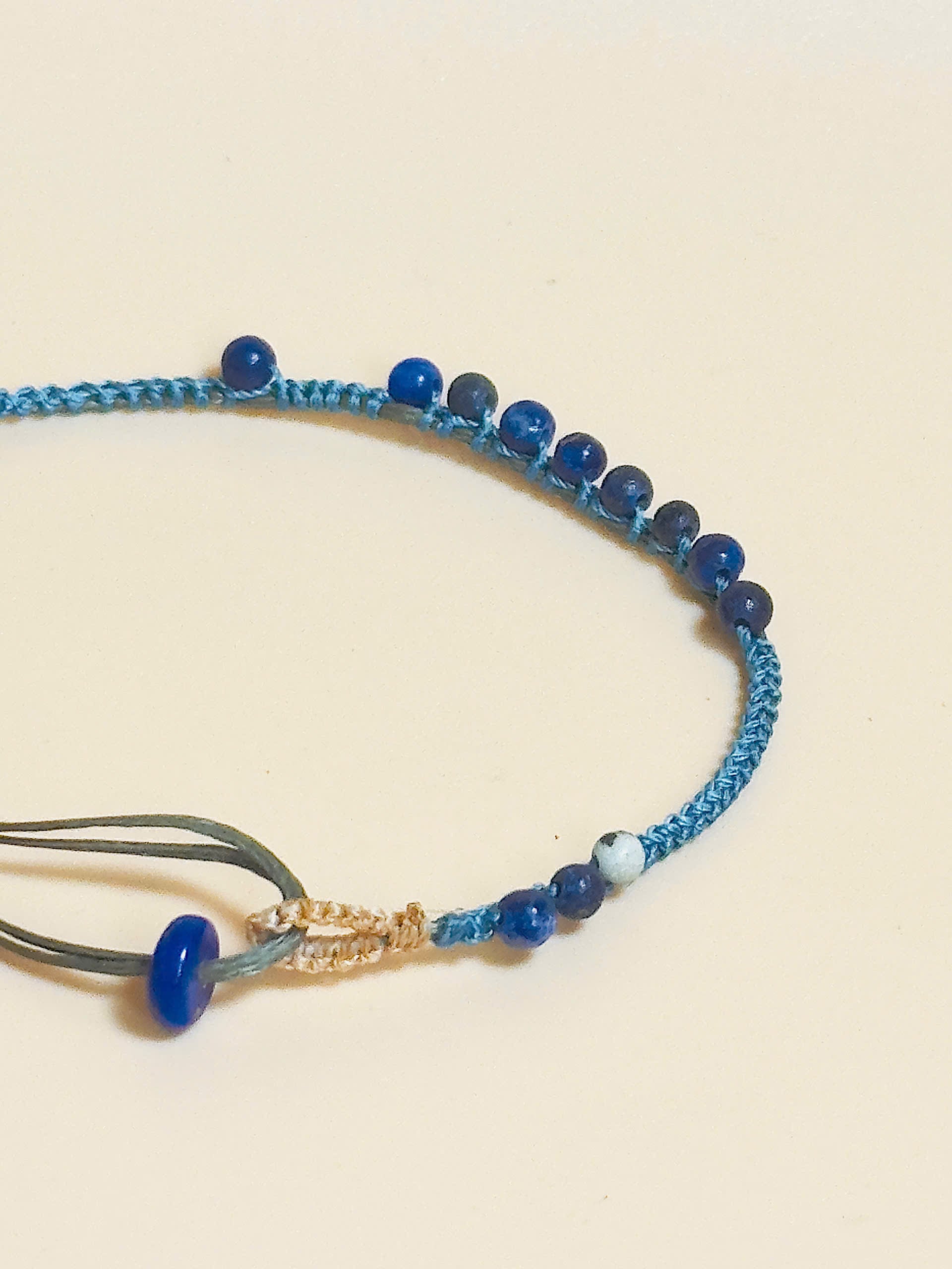 “Blue lapis lazuli bracelet with 2.5mm gemstone beads and waxed adjustable cord – calming and minimal design”